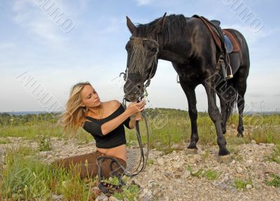 teenager and black stallion in nature