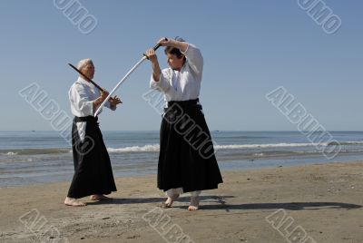 training of Aikido on the beach