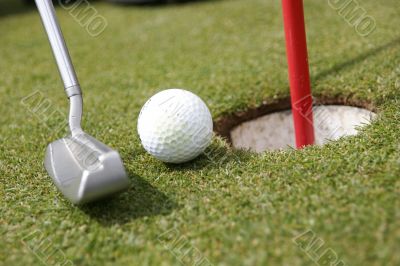 putter, ball and hole