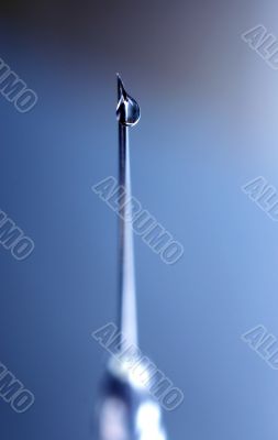 syringe close-up, focus on the drop