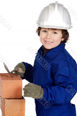 Child builder making a wall of bricks