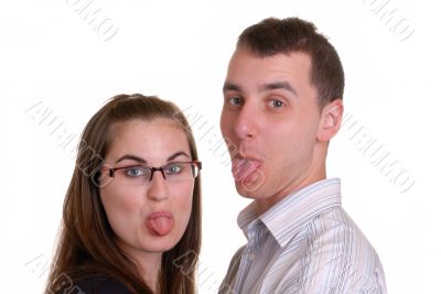 attractive young couple poke tongues out