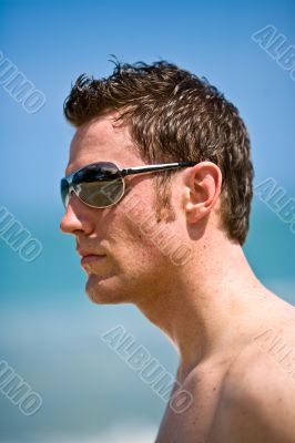 caucasian hunk at the beach with shades