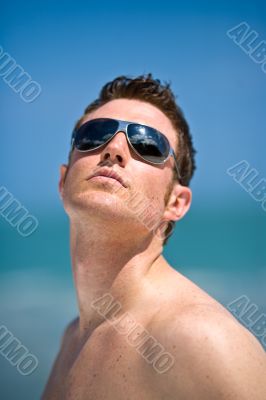 caucasian hunk at the beach with shades