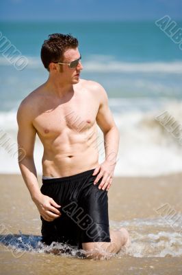 caucasian hunk at the beach with shades