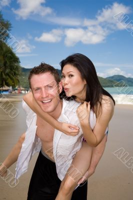 happy playful couple at the beach