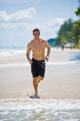 caucasian man running on the beach