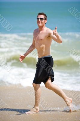 caucasian man running on the beach
