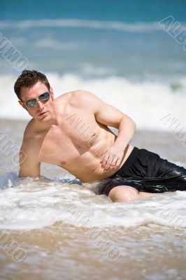 caucasian hunk at the beach with shades