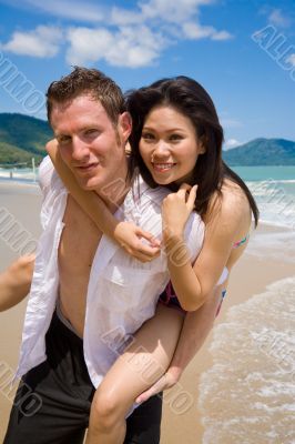 playful couple at the beach