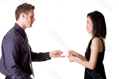 businessman exchanging name cards with woman