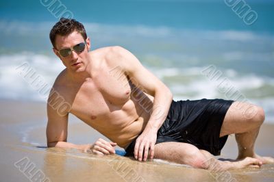 caucasian hunk at the beach with shades