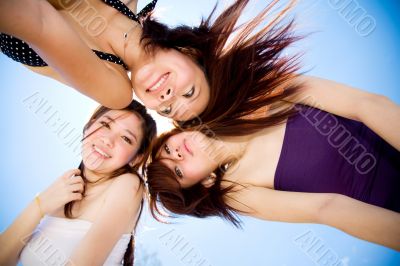 friends gather around happily under bright blue sky