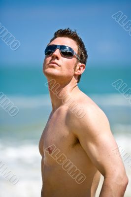 caucasian hunk at the beach with shades