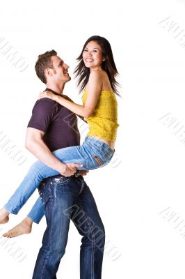 caucasian man carrying his girlfriend