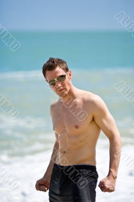 caucasian hunk at the beach with shades