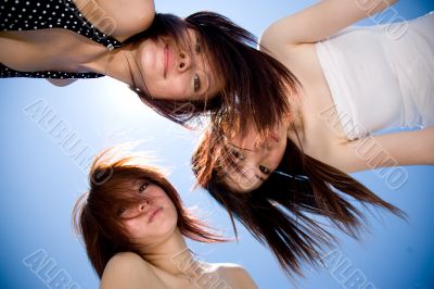girls friend having fun under sunny blue sky