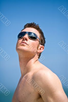 caucasian hunk at the beach with shades