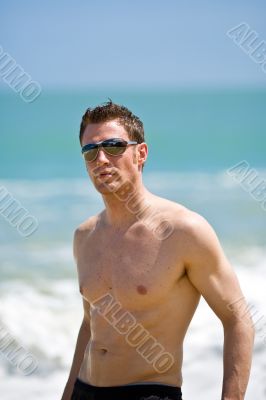 caucasian hunk at the beach with shades