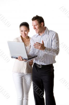 A businesswoman and businessman smile happily