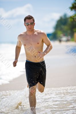 caucasian man running on the beach caucasian man running on the beach