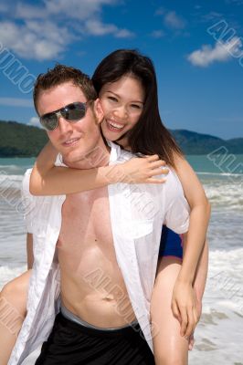 playful couple at the beach