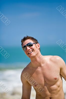 caucasian hunk at the beach with shades