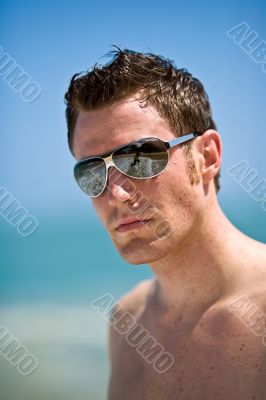 caucasian hunk at the beach with shades