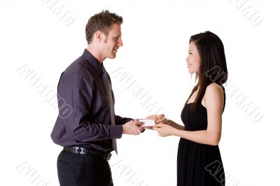 businessman exchanging name cards with woman