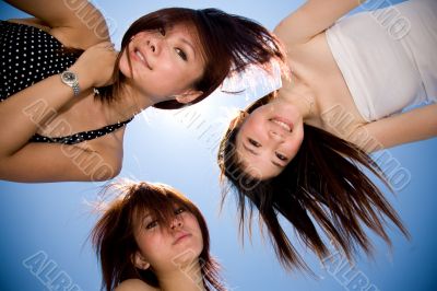 girls friend having fun under sunny blue sky