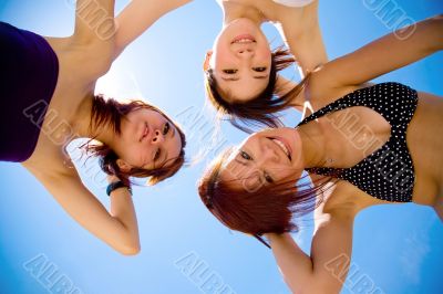 girls friend having fun under sunny blue sky