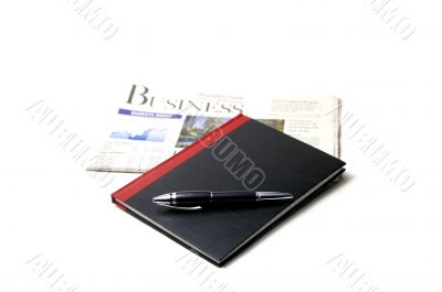 newspaper, pen and notebook