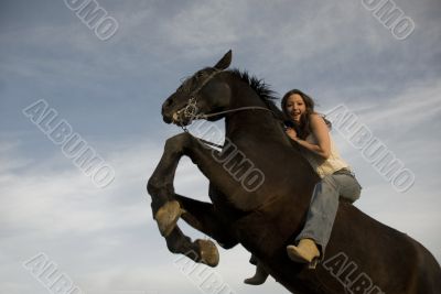 happy girl and rearing stallion