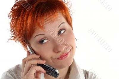 red haired woman talking by mobile phone unhappy