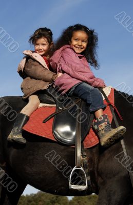 two riding little girls