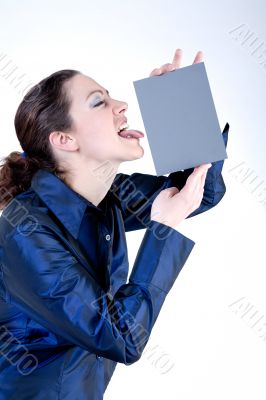 Woman with long curly hair licking a grey card