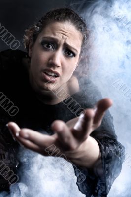 Woman with long curly hair begging