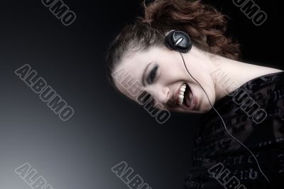 Woman with long curly hair enjoying nusic