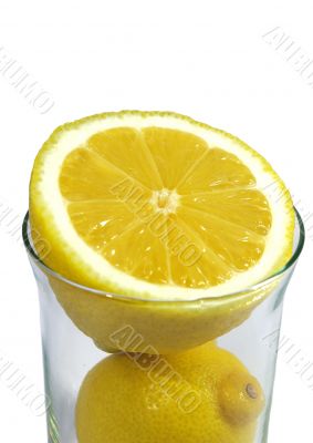 two parts of   ripe lemon in the glass