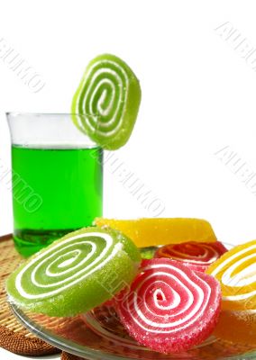 Multi-coloured  fruit candy and cold green drink