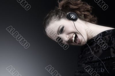 Woman with long curly hair enjoying nusic