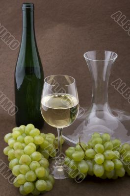 White wine with bottle, glasses and grapes