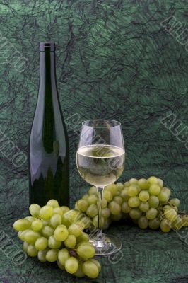 White wine with bottle, glasses and grapes
