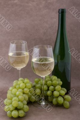 White wine with bottle, glasses and grapes