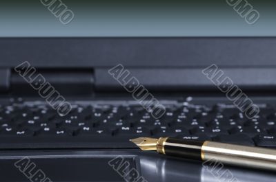 feather pen and keyboard