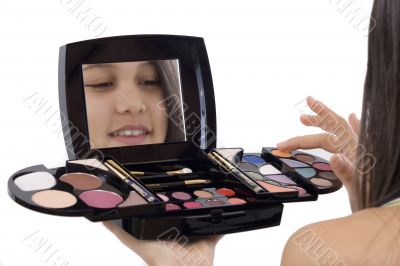 Teenager applying makeup