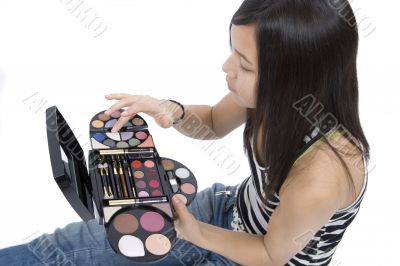 Teenager applying makeup