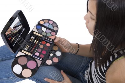 Teenager applying makeup