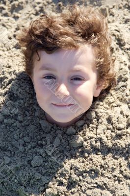 Child buried in the sand Child buried in the sand