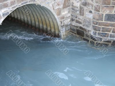 turquoise water going through a pipe